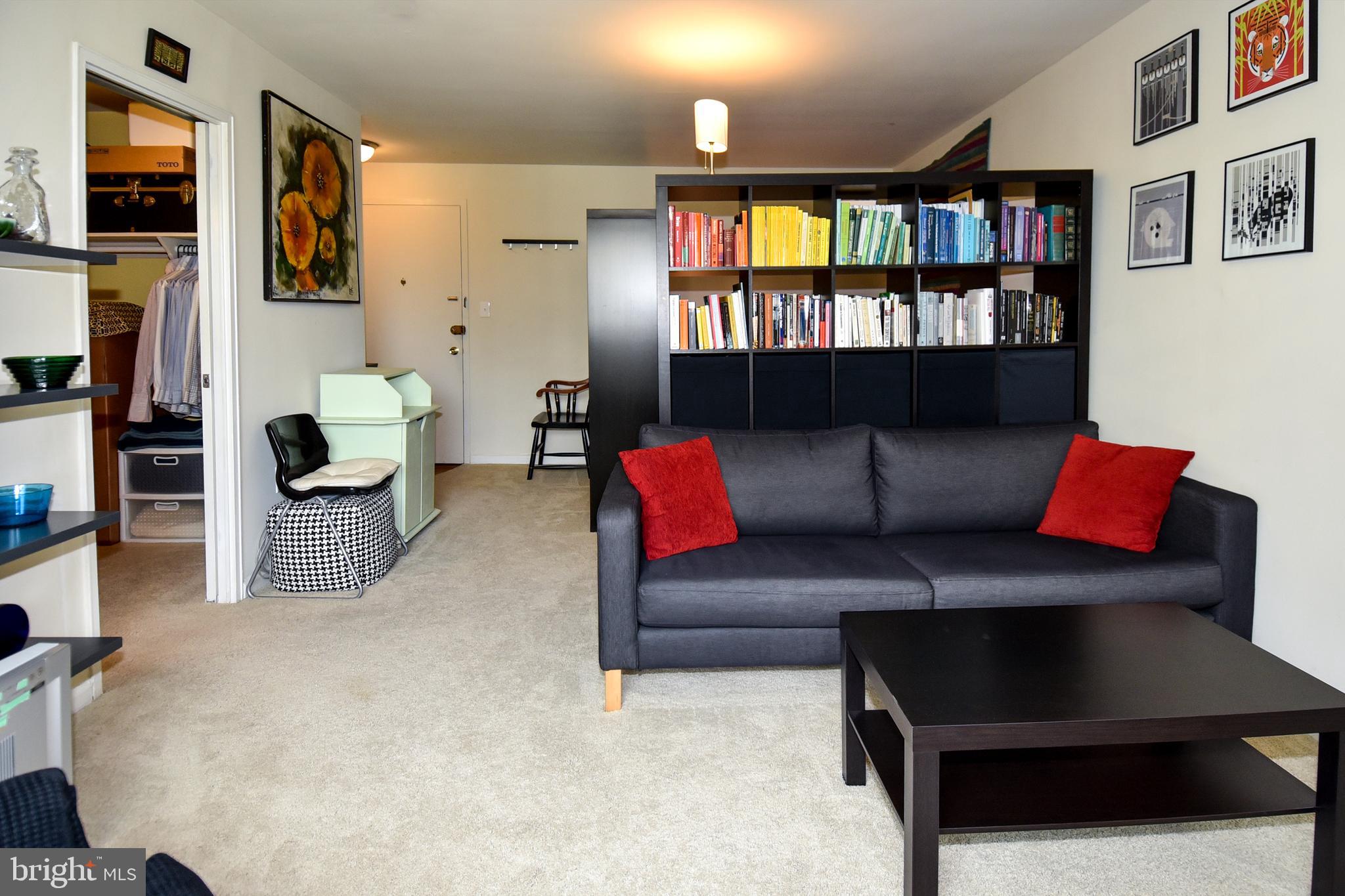 1200 South Arlington Ridge Road, Unit 510 Arlington, VA 22202 - Photo 8 of 32 a living room with furniture and a book shelf