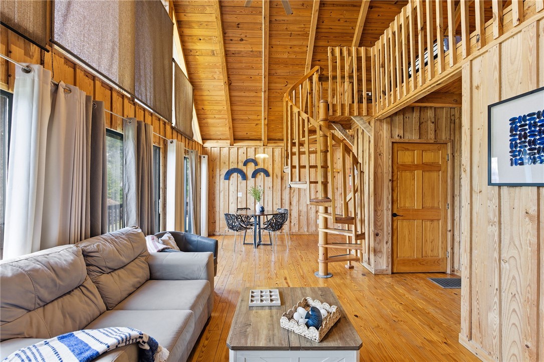 1 Kitty Hawk Lane Six Mile, SC 29682 - Photo 11 of 46 This living area features rich wood, vaulted ceilings, and a charming spiral staircase to an upper loft.