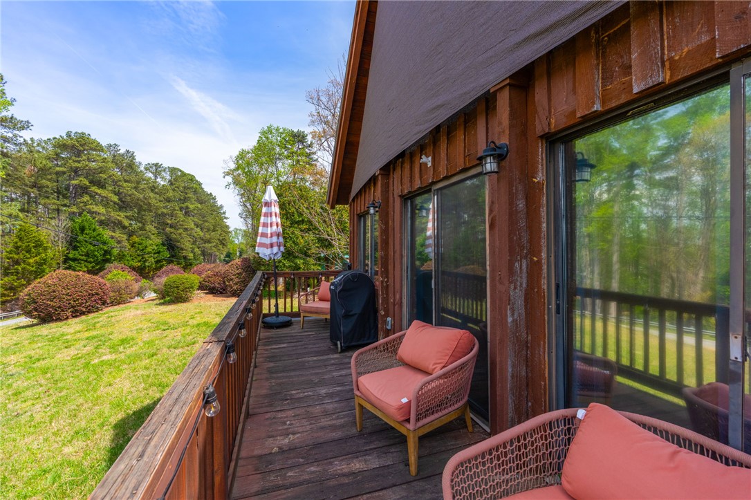 1 Kitty Hawk Lane Six Mile, SC 29682 - Photo 26 of 46 This charming outdoor deck offers a serene escape, perfect for enjoying the lush, verdant surroundings.