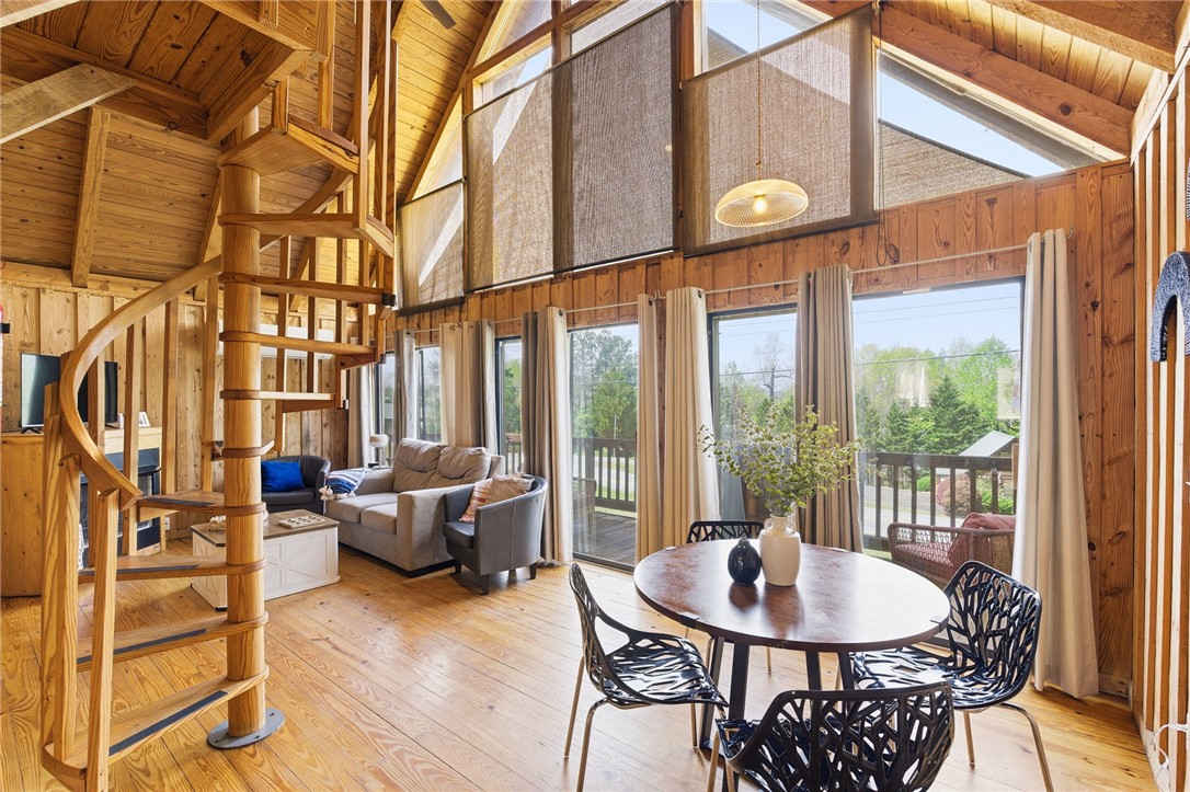 1 Kitty Hawk Lane Six Mile, SC 29682 - Photo 3 of 46 This airy space showcases soaring ceilings, a spiral staircase, and expansive windows that offer captivating views.