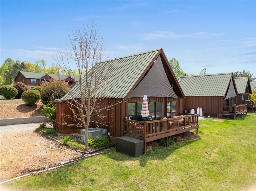 1 Kitty Hawk Lane Six Mile, SC 29682 - Photo 35 of 46 This charming retreat offers a private deck, perfect for outdoor living and enjoying the serene surroundings.