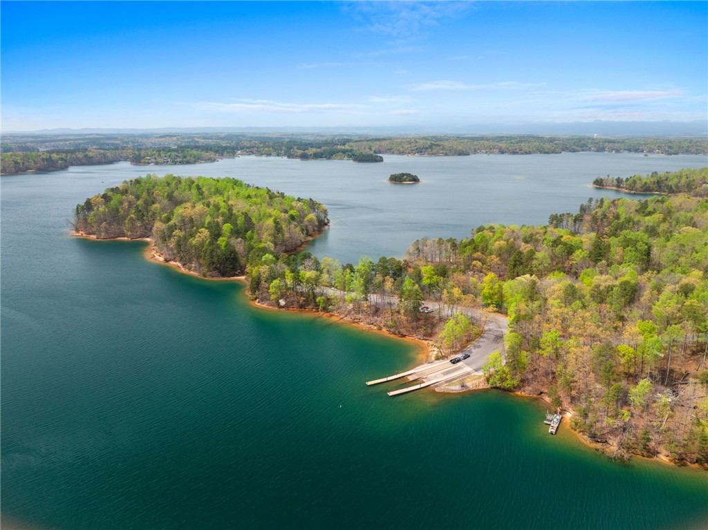 1 Kitty Hawk Lane Six Mile, SC 29682 - Photo 38 of 46 This scenic lake view features lush tree-lined shores, serene waters, and a convenient boat ramp.
