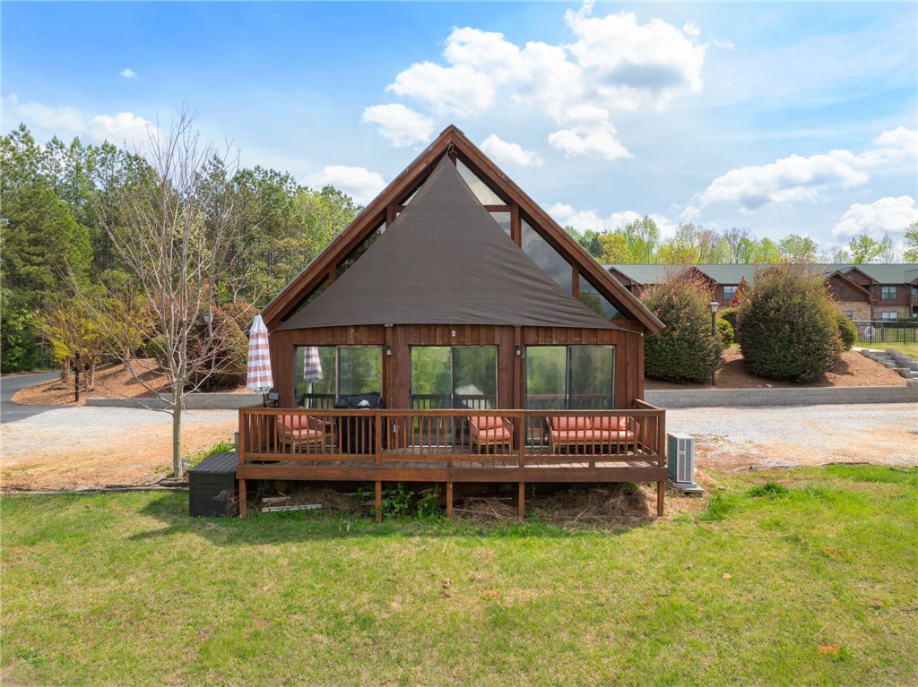 1 Kitty Hawk Lane Six Mile, SC 29682 - Photo 4 of 46 This charming A-frame cabin offers a spacious deck and rustic appeal, perfect for serene outdoor living.