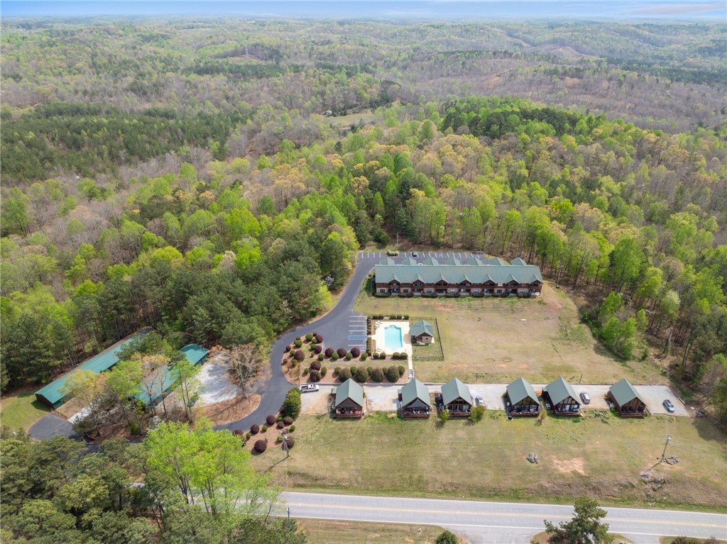 1 Kitty Hawk Lane Six Mile, SC 29682 - Photo 40 of 46 This expansive property features multiple charming structures nestled amidst abundant natural beauty and lush greenery.