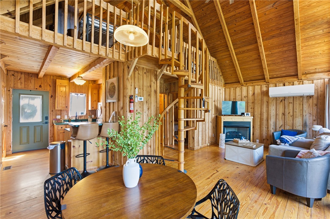 1 Kitty Hawk Lane Six Mile, SC 29682 - Photo 8 of 46 This inviting interior features rustic wood paneling and a charming spiral staircase.