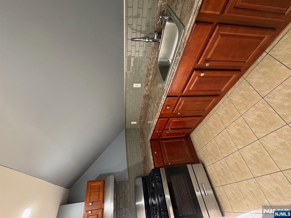 121 Rutgers Street, Unit 3 Belleville, NJ 07109 - Photo 2 of 11 a kitchen with stainless steel appliances a sink stove and cabinets