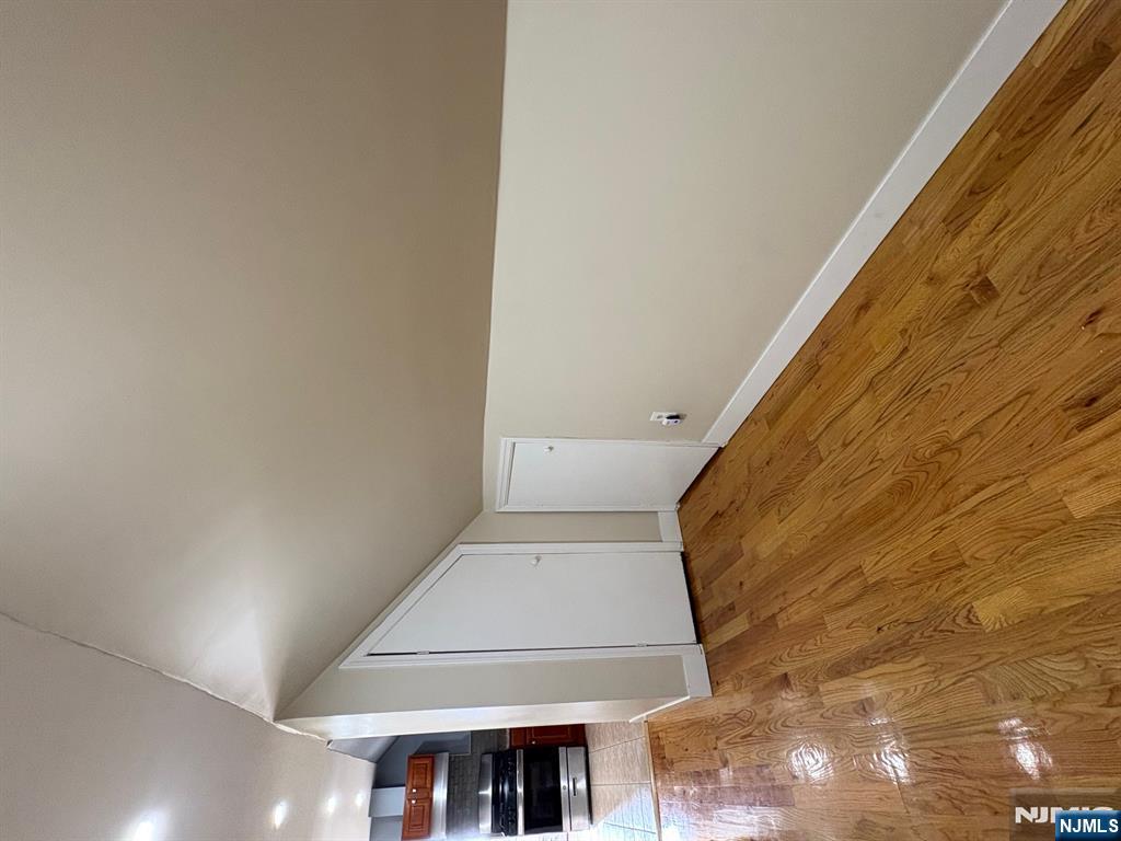 121 Rutgers Street, Unit 3 Belleville, NJ 07109 - Photo 7 of 11 a view of an empty room and wooden floor