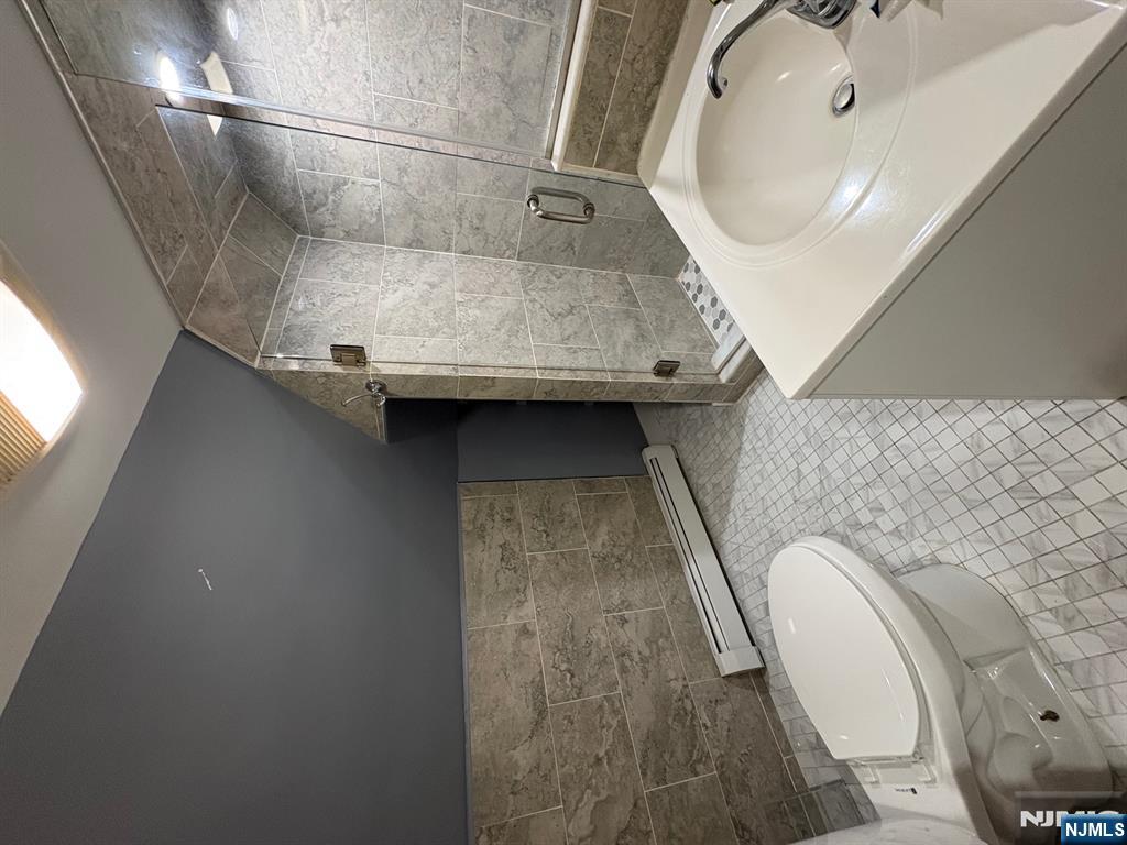 121 Rutgers Street, Unit 3 Belleville, NJ 07109 - Photo 8 of 11 a bathroom with a sink a toilet and shower