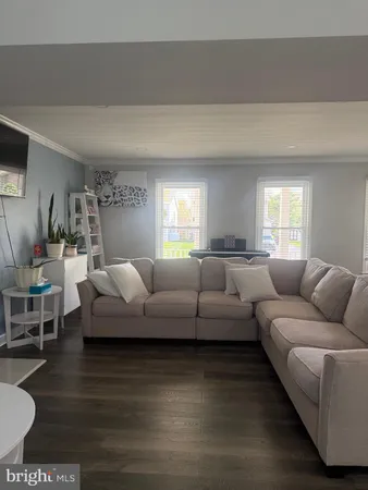 a living room with furniture wooden floor and a rug