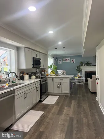a kitchen with cabinets a sink and appliances