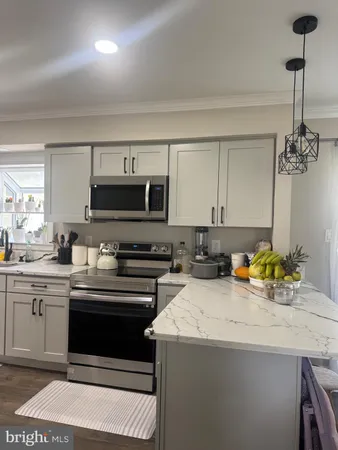 a kitchen with stainless steel appliances a stove sink and cabinets