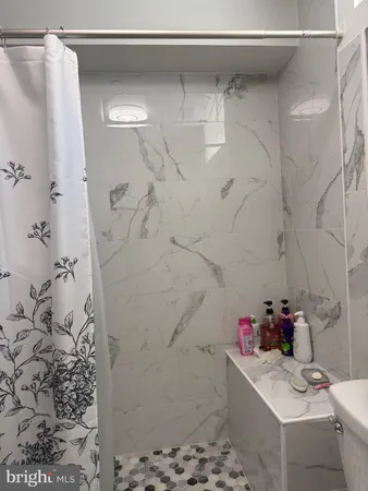 a bathroom with a bathtub and shower