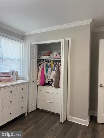 a view of a bedroom with baby crib and bedroom