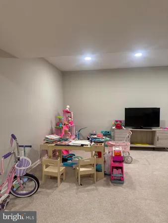 a view of a livingroom with furniture and a flat screen tv