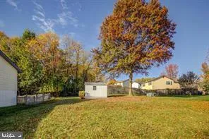 a yellow house with trees in front of it
