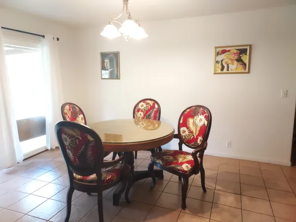 a view of a room with furniture and wooden floor