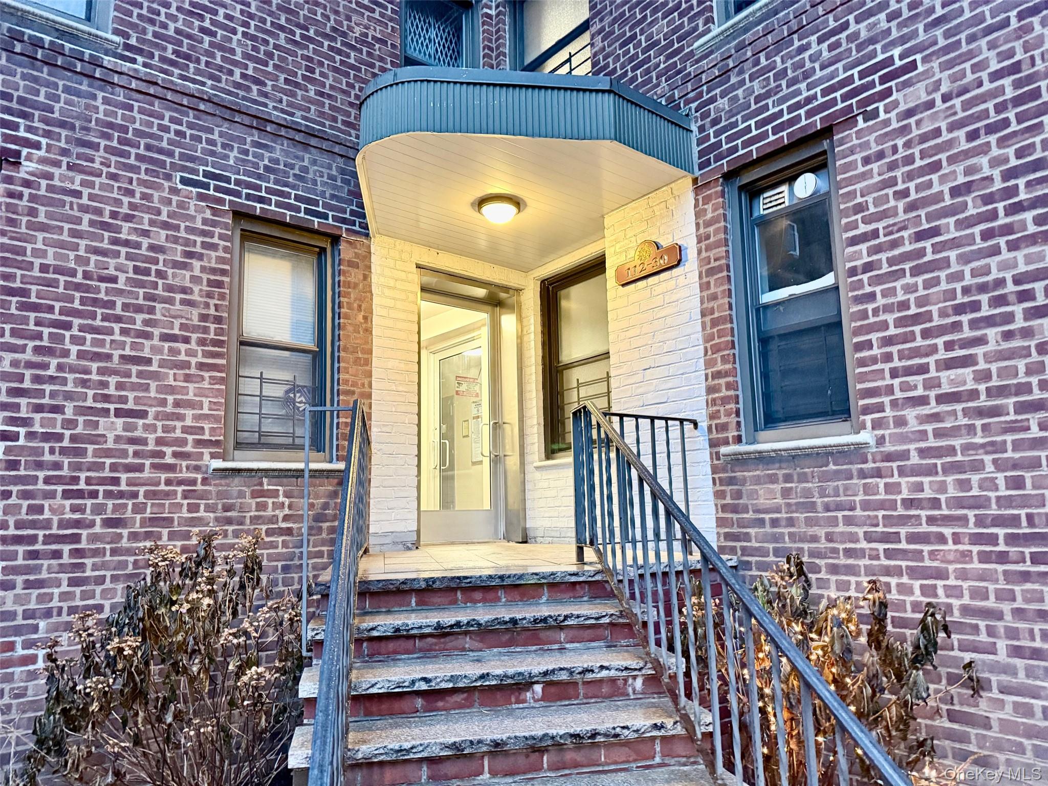 a view of front door of house with stairs