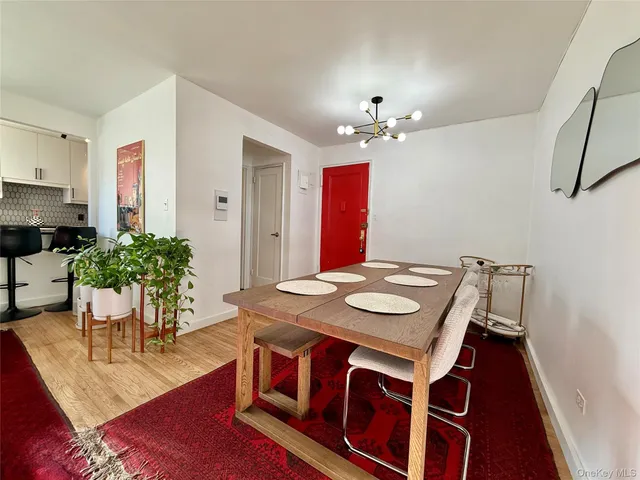 a view of a dining room with furniture and a chandelier