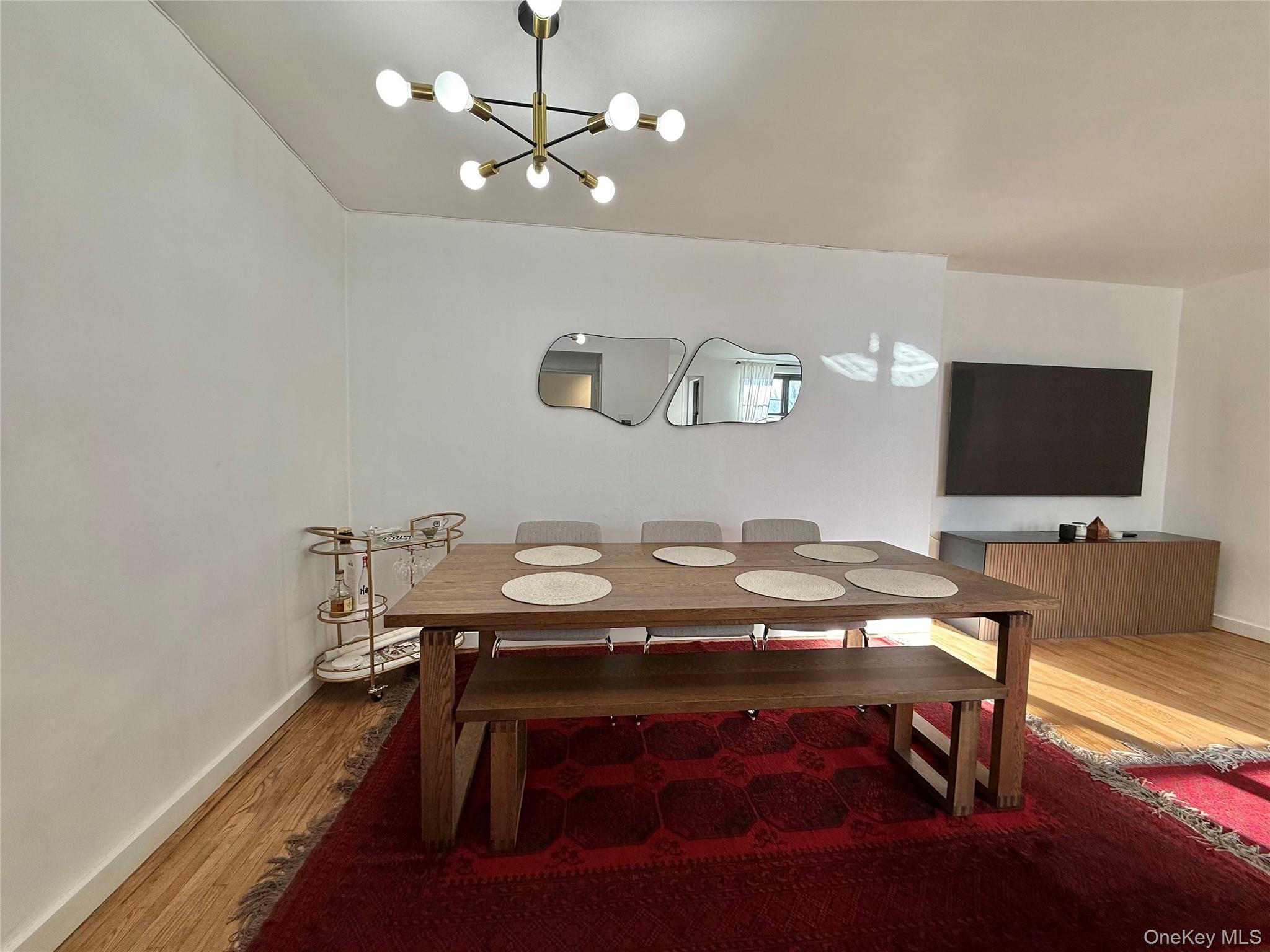 112-30 Northern Boulevard, Unit 2A Queens, NY 11368 - Photo 15 of 40 Dining space with wood finished floors and a chandelier