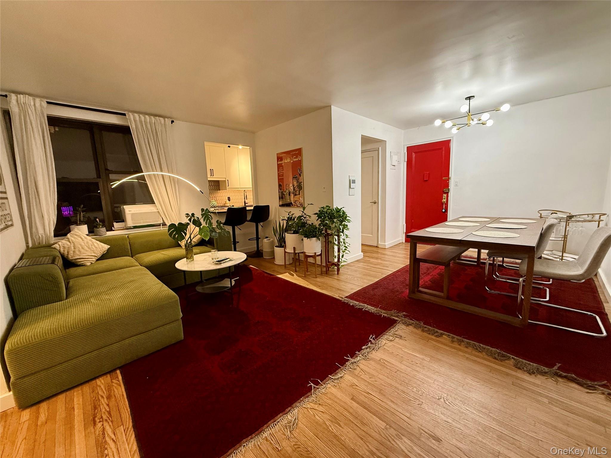 112-30 Northern Boulevard, Unit 2A Queens, NY 11368 - Photo 19 of 40 Living area with light wood-style flooring and a chandelier