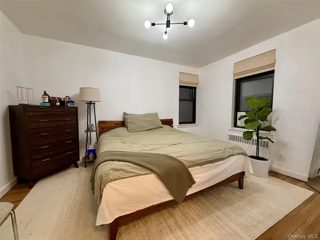 a bedroom with a bed and a potted plant