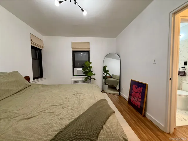 a bed room with a bed and a tv
