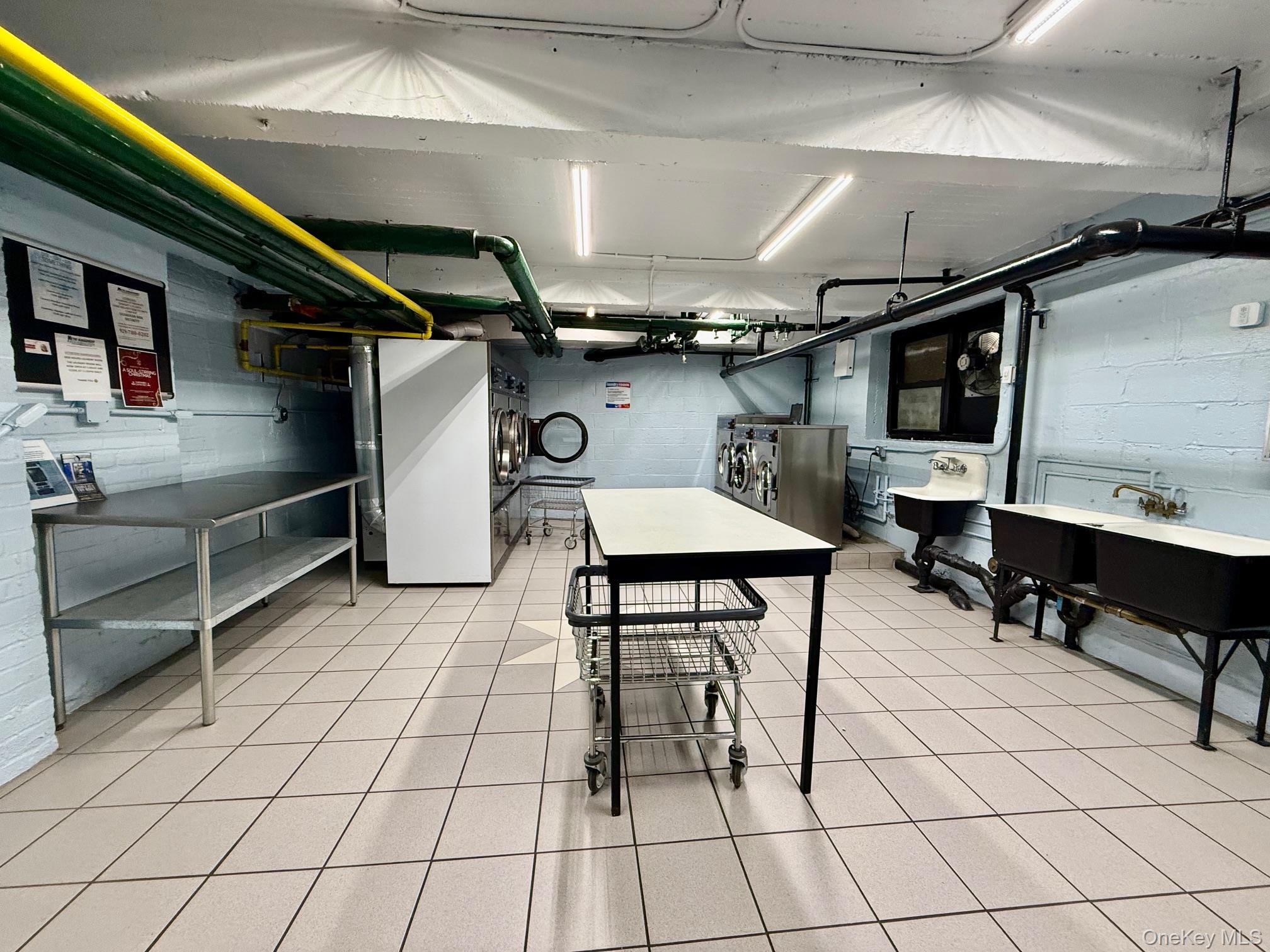 112-30 Northern Boulevard, Unit 2A Queens, NY 11368 - Photo 25 of 40 Below grade area featuring concrete block wall and light tile patterned flooring