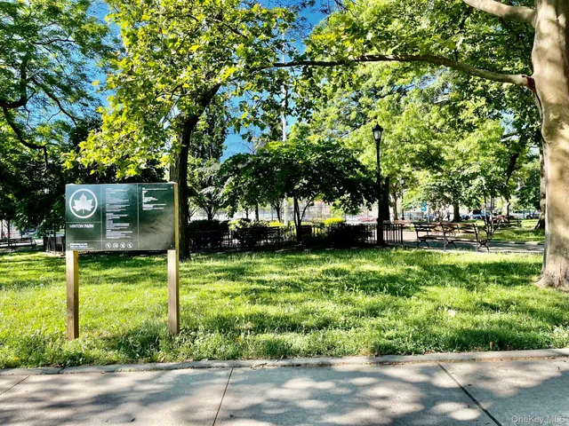 a front view of a residential apartment building with a yard