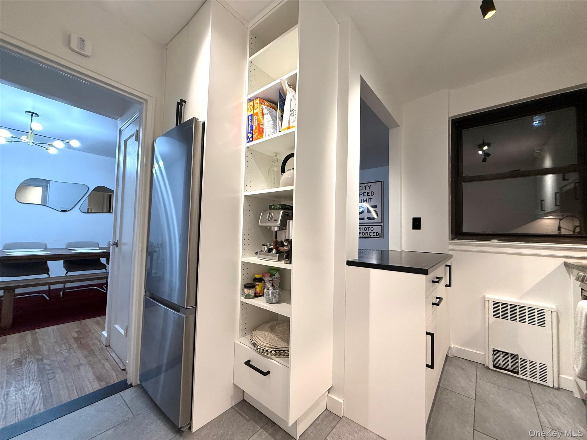 112-30 Northern Boulevard, Unit 2A Queens, NY 11368 - Photo 10 of 40 Stainless steel appliances. Pantry/storage. Island with seating area