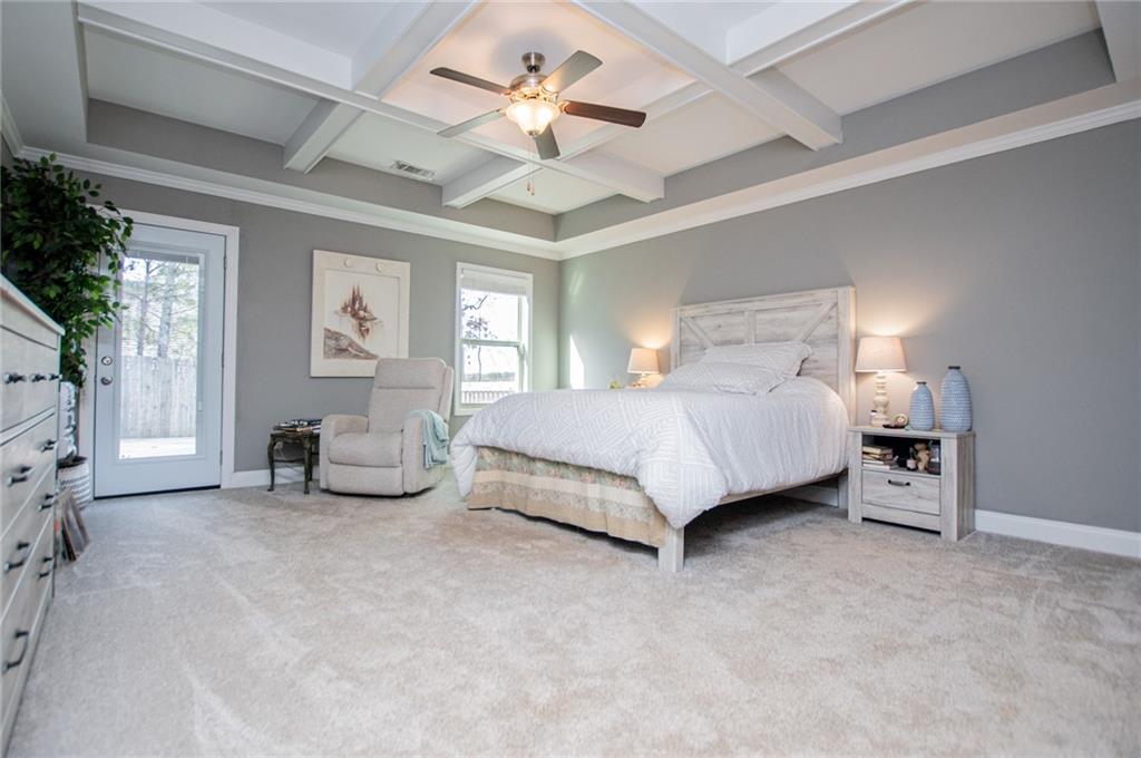 201 Overton Point Carrollton, GA 30116 - Photo 14 of 43 a spacious bedroom with a bed a couch and ceiling fan