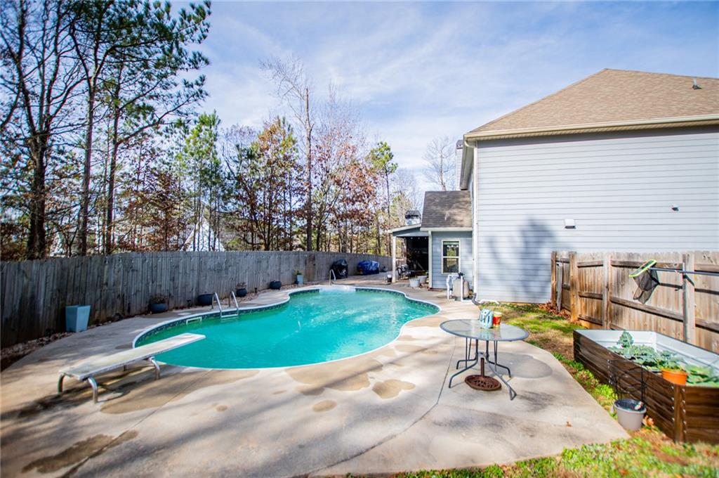 201 Overton Point Carrollton, GA 30116 - Photo 40 of 43 a view of a backyard with furniture and a fire pit