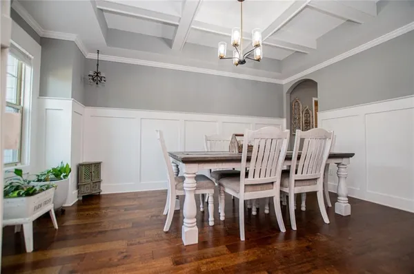 a kitchen with stainless steel appliances granite countertop wooden cabinets a stove a sink and a wooden floors