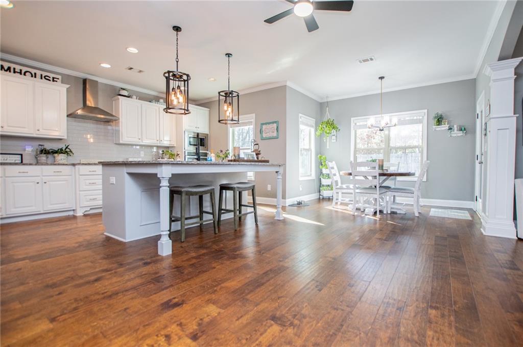 201 Overton Point Carrollton, GA 30116 - Photo 9 of 43 a large kitchen with cabinets chairs and wooden floor