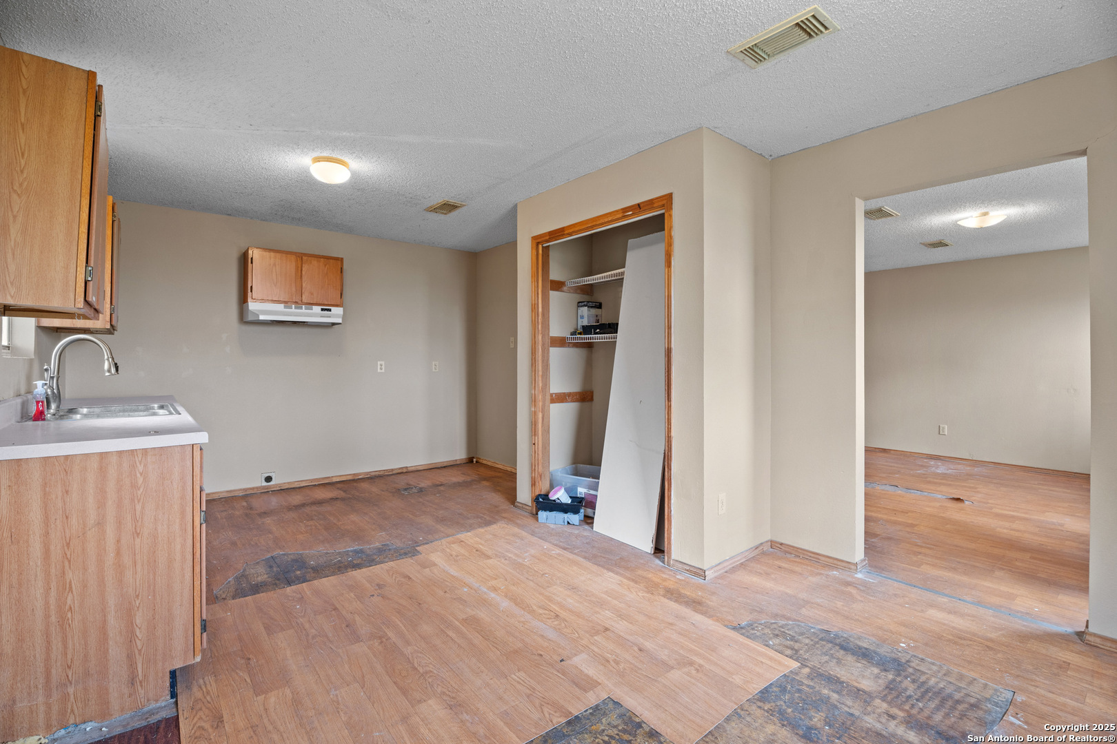 2862 Wetz Road Santa Clara, TX 78124 - Photo 11 of 37 a view of a room with wooden floor and a ceiling fan