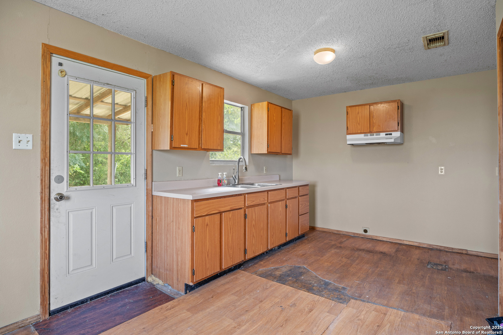 2862 Wetz Road Santa Clara, TX 78124 - Photo 13 of 37 a room with a sink cabinets and a window