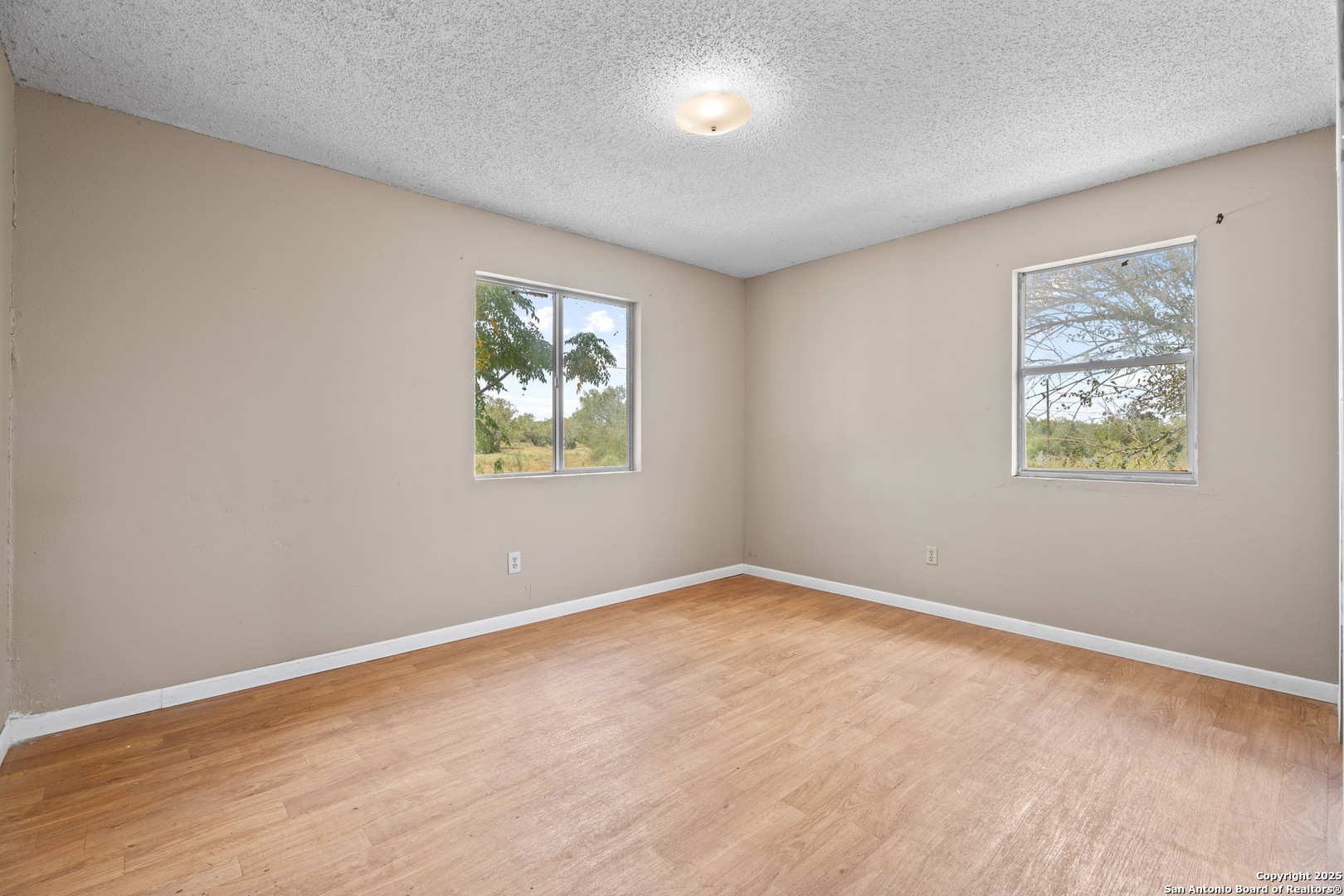 2862 Wetz Road Santa Clara, TX 78124 - Photo 19 of 37 a view of an empty room with a window and a painting on the wall