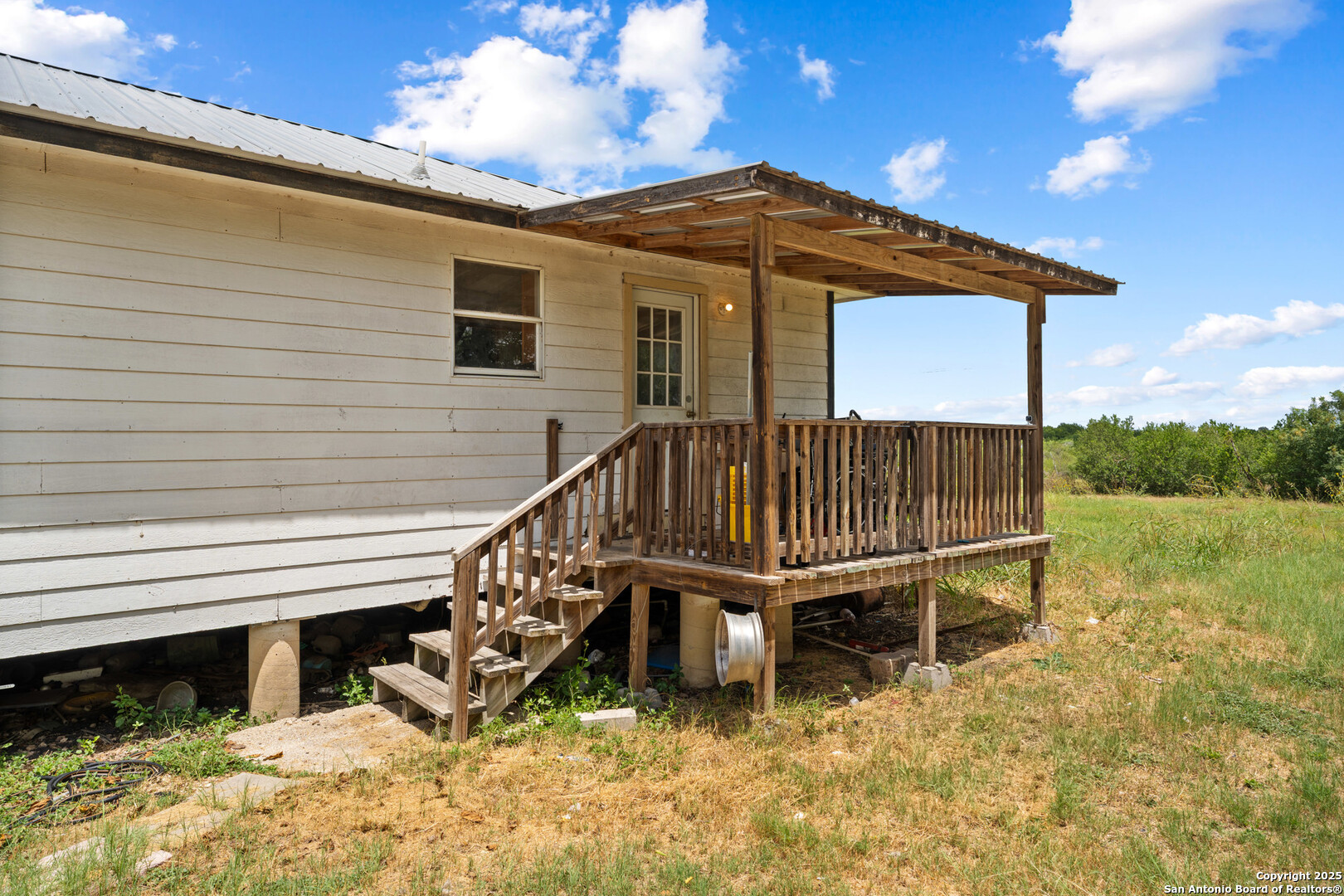 2862 Wetz Road Santa Clara, TX 78124 - Photo 25 of 37 a view of a house with a wooden deck and furniture