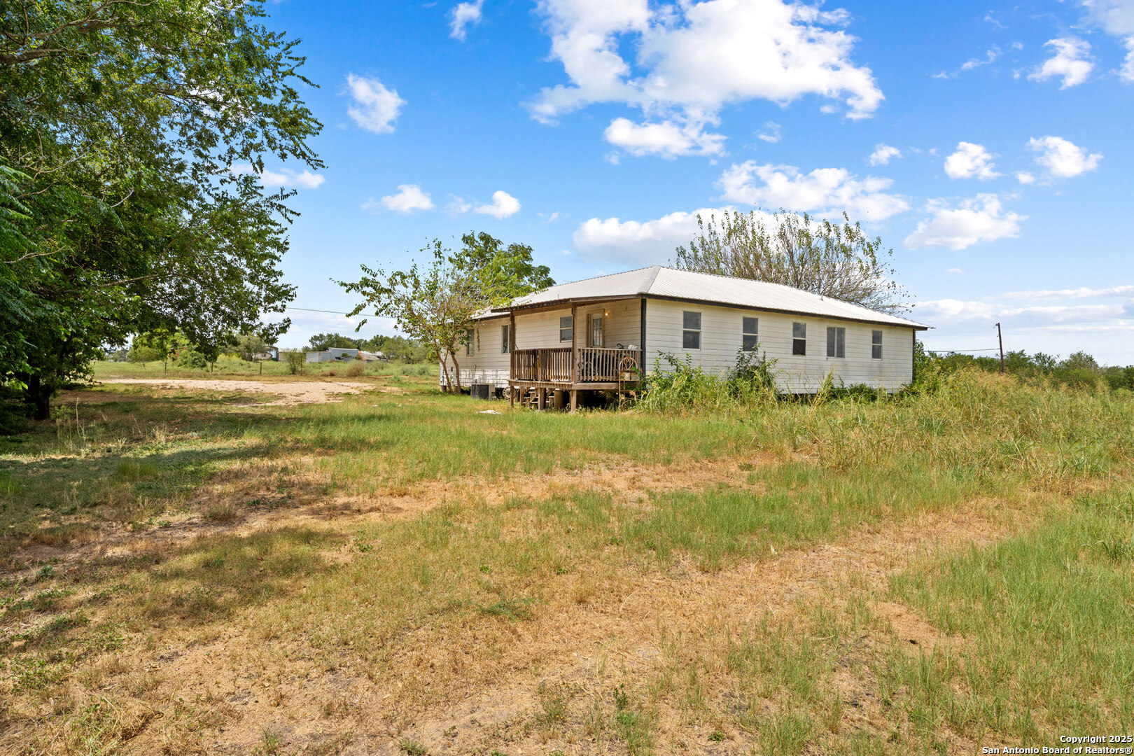 2862 Wetz Road Santa Clara, TX 78124 - Photo 26 of 37 a view of a house with a big yard and large trees