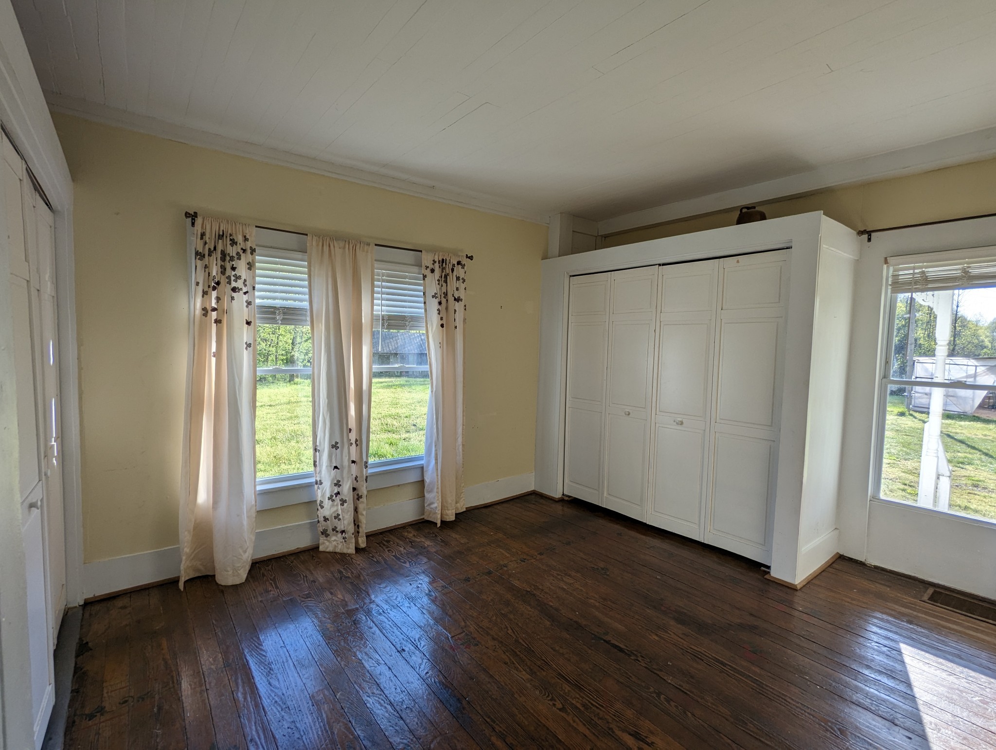 1097 Lower Lick Creek Road Linden, TN 37096 - Photo 11 of 45 an empty room with wooden floor and windows