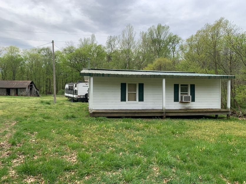 1097 Lower Lick Creek Road Linden, TN 37096 - Photo 31 of 45 a backyard of a house with table and chairs