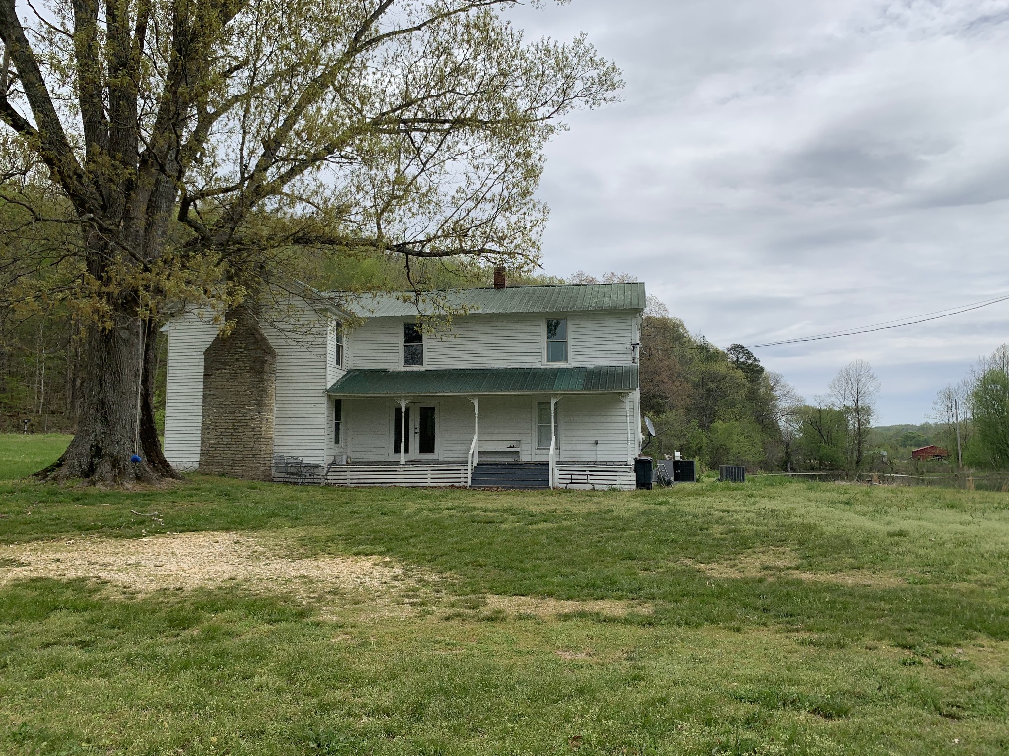 1097 Lower Lick Creek Road Linden, TN 37096 - Photo 4 of 45 a view of a building with a yard