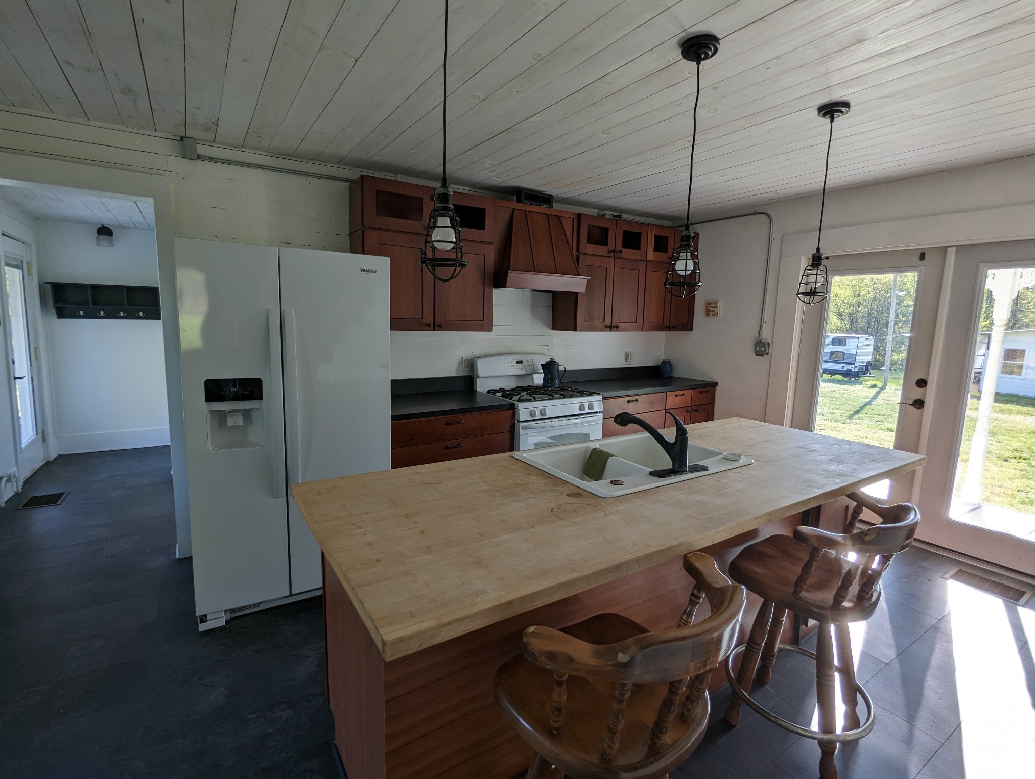 1097 Lower Lick Creek Road Linden, TN 37096 - Photo 6 of 45 a kitchen with stainless steel appliances granite countertop a refrigerator a sink dishwasher a dining table and chairs with wooden floor