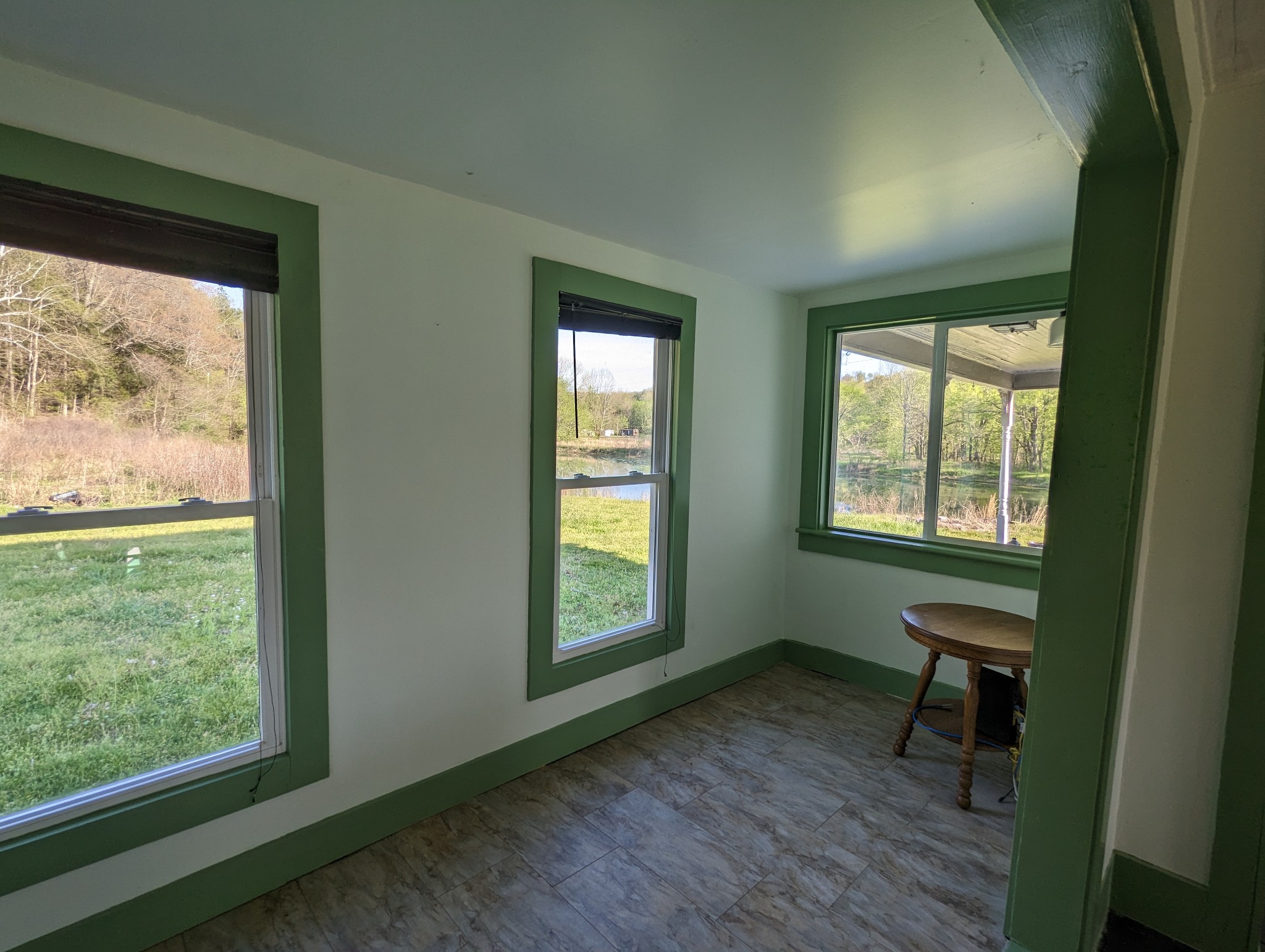1097 Lower Lick Creek Road Linden, TN 37096 - Photo 9 of 45 a view of an empty room with wooden floor and a window