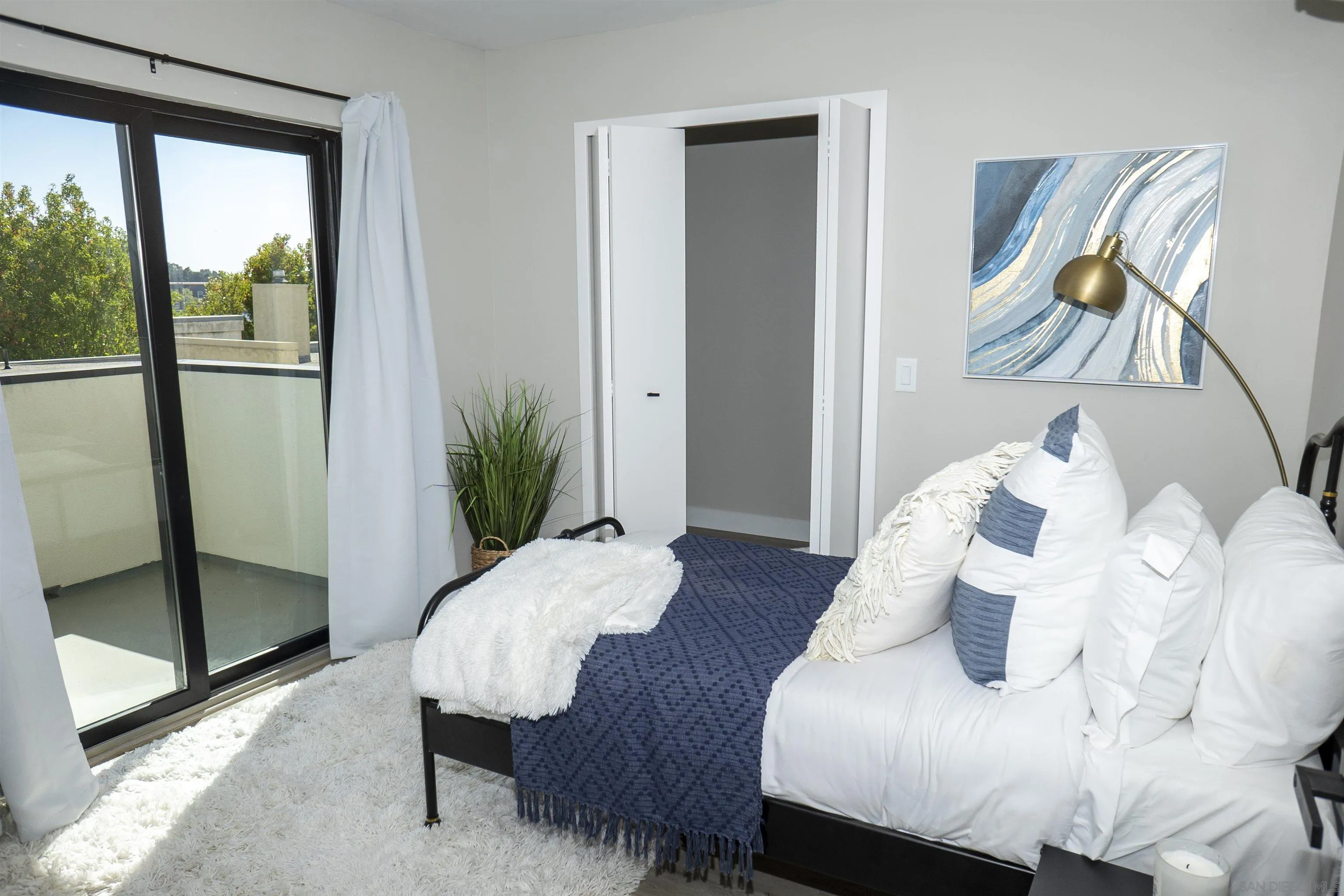 5548 Riley Street San Diego, CA 92110 - Photo 14 of 15 a living room with furniture and a potted plant