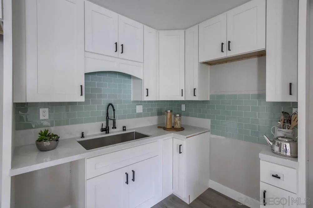 5548 Riley Street San Diego, CA 92110 - Photo 7 of 15 a kitchen with stainless steel appliances granite countertop a sink a stove and white cabinets
