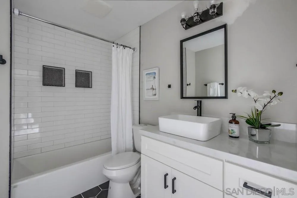 5548 Riley Street San Diego, CA 92110 - Photo 9 of 15 a bathroom with a sink a toilet and shower