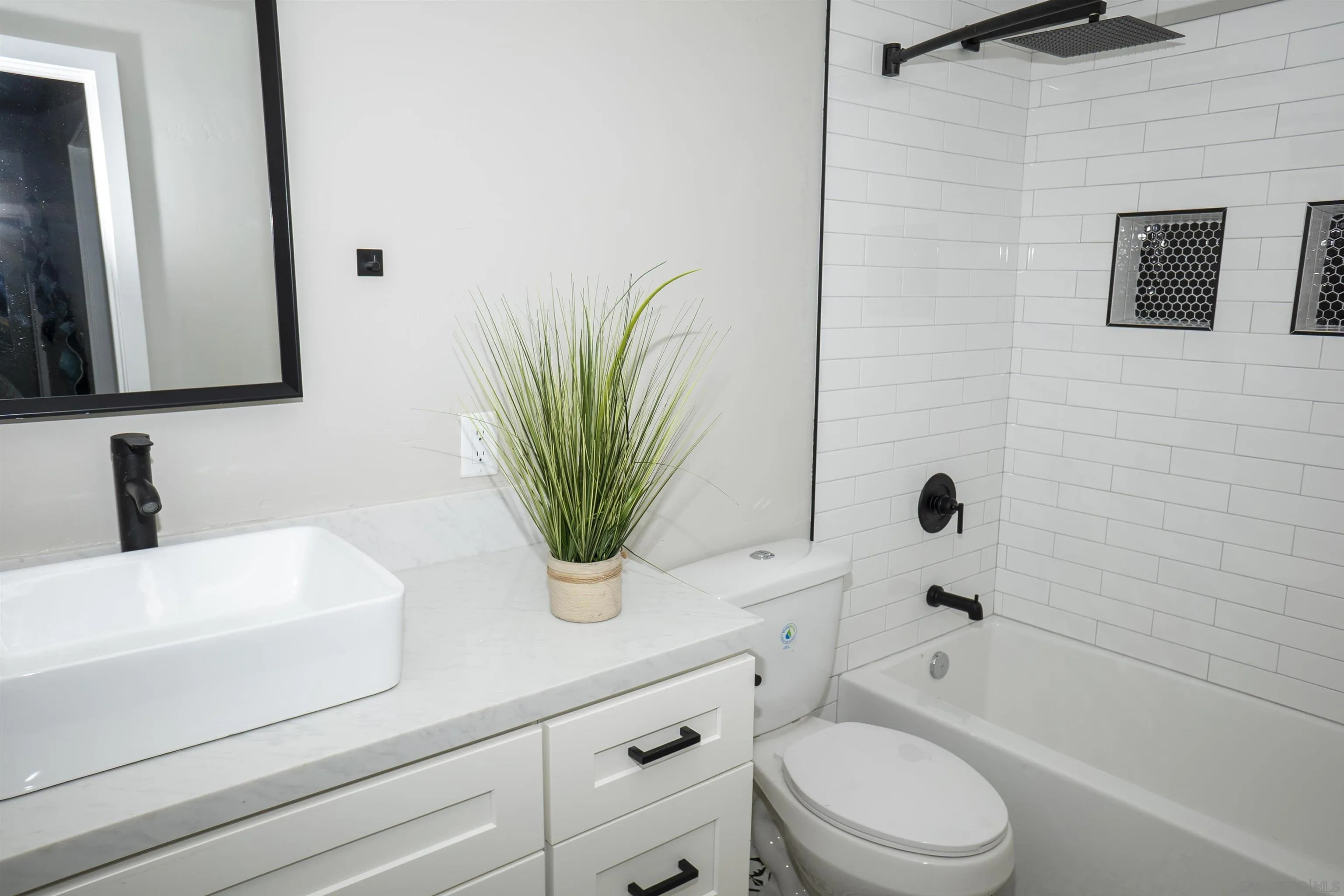 5548 Riley Street San Diego, CA 92110 - Photo 10 of 15 a bathroom with a sink a toilet a tub and mirror