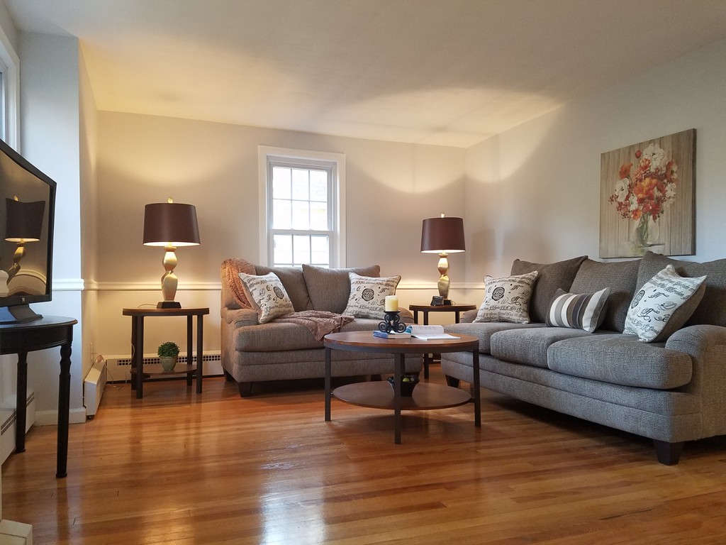 109 Prouty Street Springfield, MA 01119 - Photo 3 of 5 a living room with furniture and a flat screen tv