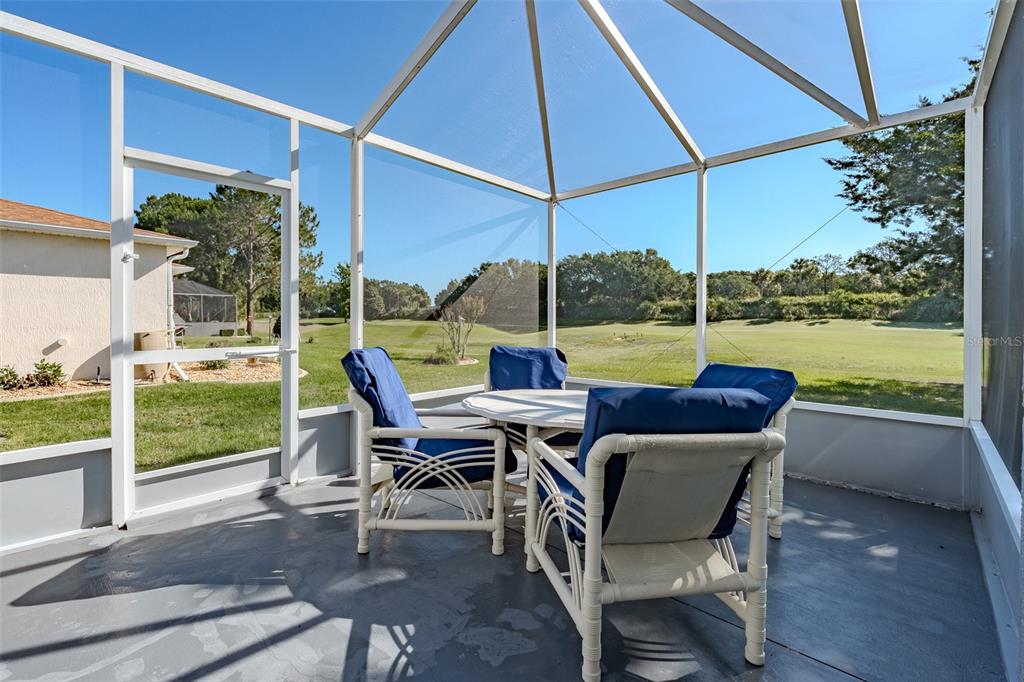 15143 Southwest 14th Avenue Road Ocala, FL 34473 - Photo 18 of 53 a view of an outdoor sitting area with furniture and umbrella