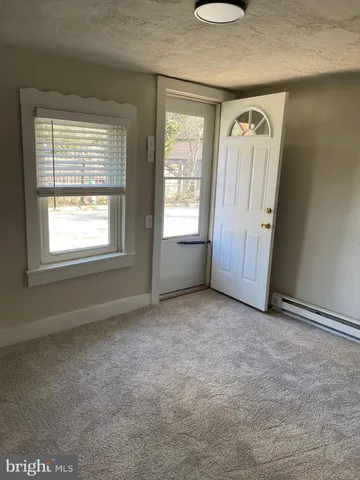 an empty room with windows and closet